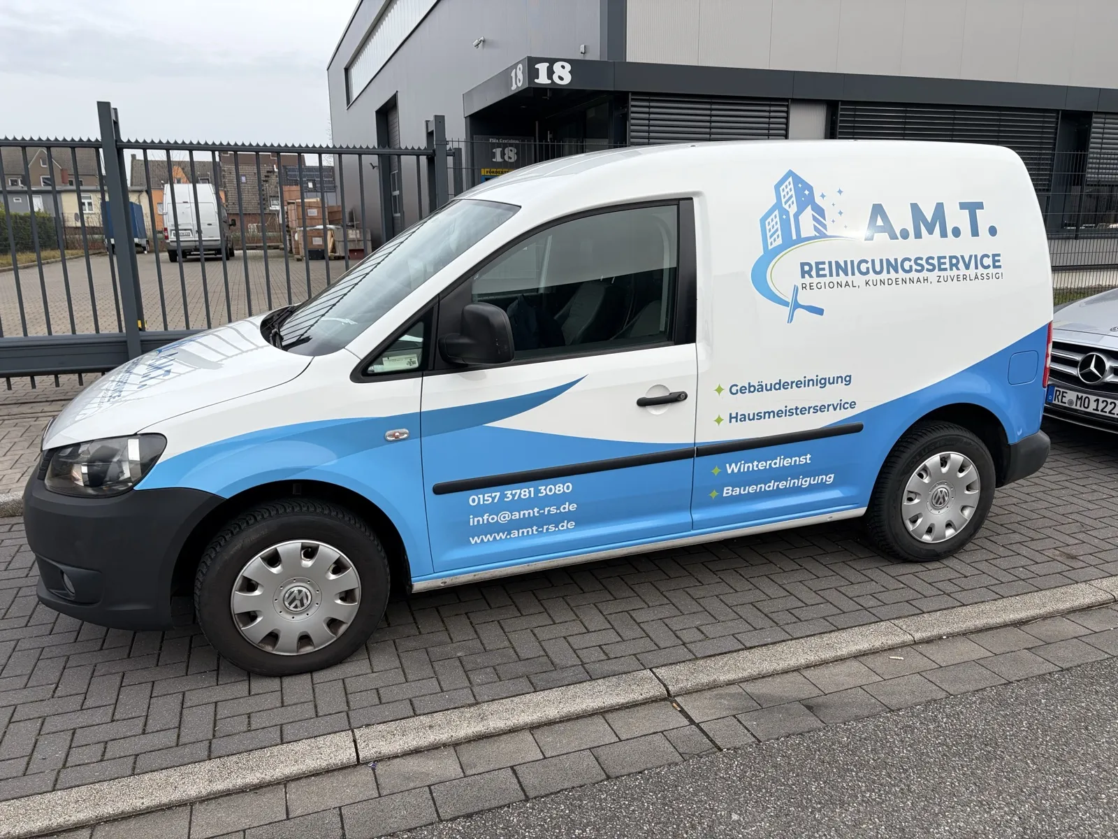 Firmenfahrzeug von A.M.T., VW Caddy in den Markenfarben